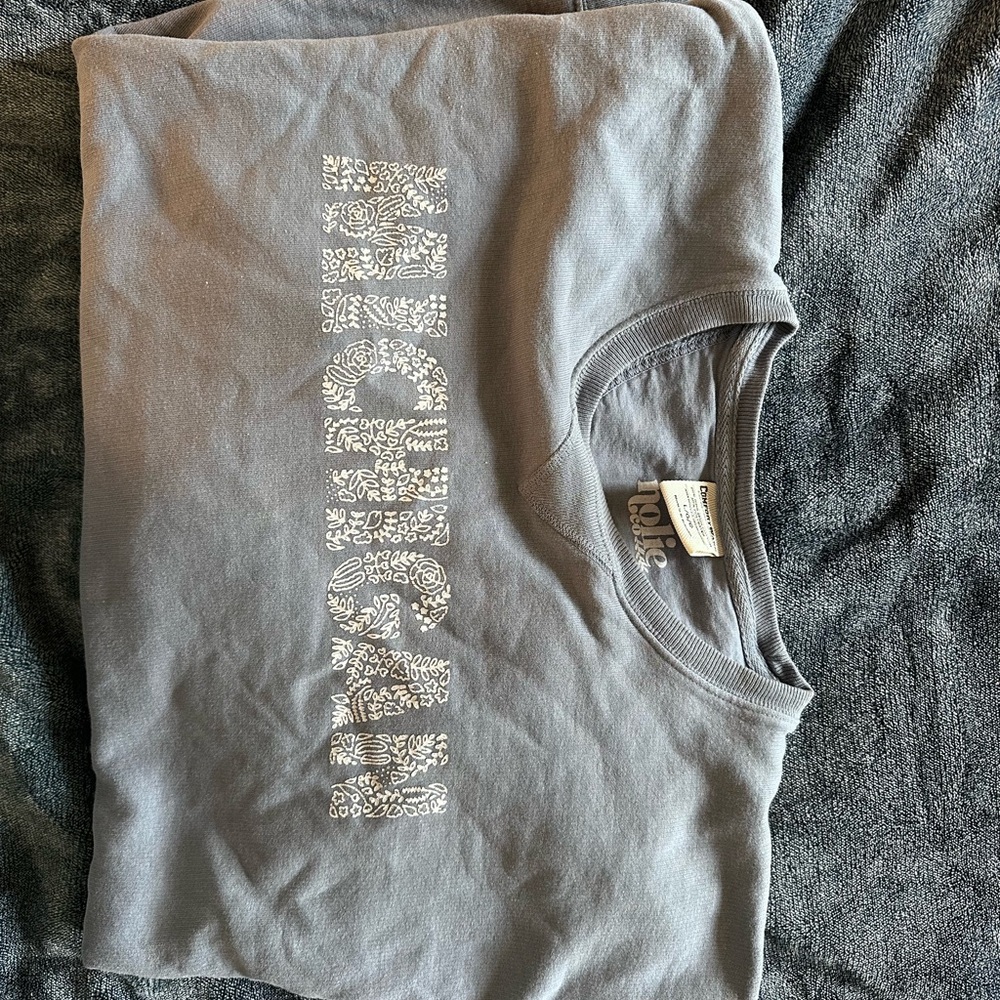 Light blue colored crew neck Michigan sweatshirt with floral design. Size L